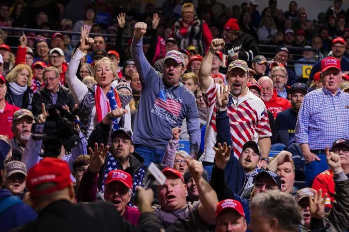 Crowd of supporters cheering at an indoor political rally