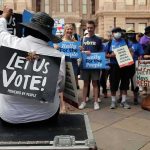Shock Vote Upends Abortion Limits Protesters holding signs at a voting rights rally