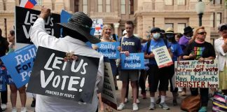 Shock Vote Upends Abortion Limits Protesters holding signs at a voting rights rally