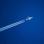 Airplane leaving contrails in a clear blue sky