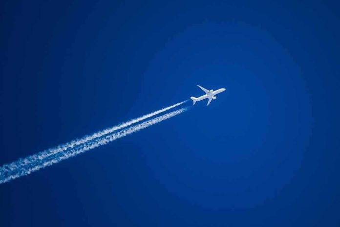 Airplane leaving contrails in a clear blue sky