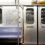 Migration Uproar After Train Allegations Subway car interior with stainless doors and empty blue bench