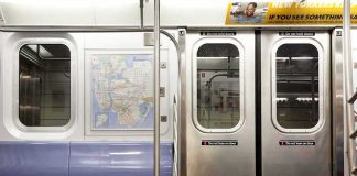 Migration Uproar After Train Allegations Subway car interior with stainless doors and empty blue bench