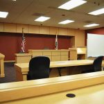 Sex In Chambers Sparks IMPEACHMENT Firestorm Interior view of an empty courtroom with wooden furniture and American flags