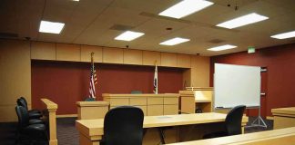Sex In Chambers Sparks IMPEACHMENT Firestorm Interior view of an empty courtroom with wooden furniture and American flags