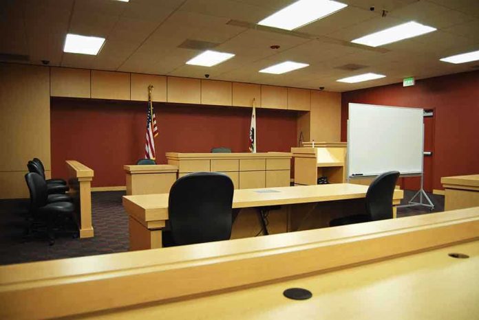 shutterstock_6768826 Interior view of an empty courtroom with wooden furniture and American flags