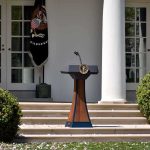 Podium with presidential seal in a garden colonnade
