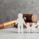 Family cutout figures with judge's gavel in background