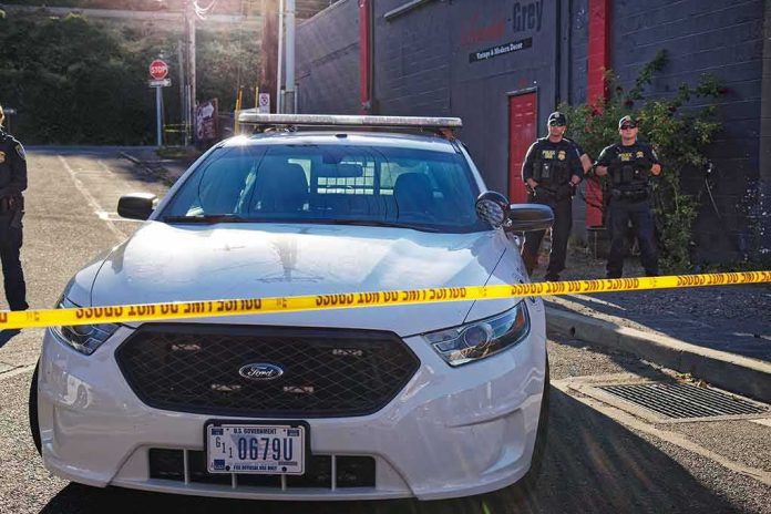 Aaron Guiel near police car behind yellow caution tape