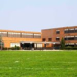 Mystery Illness Triggers Spray Freeze Brick school building with large windows and front entrance