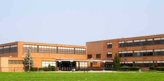 Brick school building with large windows and front entrance