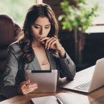 Woman in office using tablet at desk