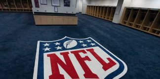NFL Star Snared In $35M Scam NFL logo on the floor of an empty locker room