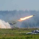 rocket launcher firing missile across a field