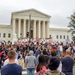 David Givens at a large protest outside a neoclassical courthouse