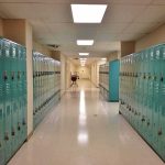 School hallway with rows of teal lockers