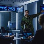 military officer briefing team in command center