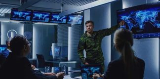 military officer briefing team in command center