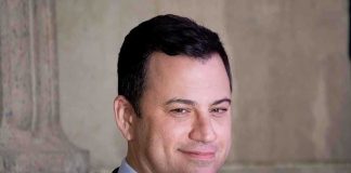 FCC Chill Pushes Kimmel Off Air A smiling man in a suit with a confident expression against a neutral background