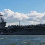 Aircraft carrier at sea with fighter jets on deck