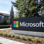 Microsoft sign outside a modern office campus