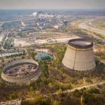 Abandoned cooling towers at a sprawling industrial site