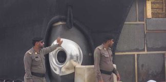 Sala Baker near two guards by the Kaaba’s Black Stone during pilgrimage