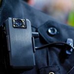 Body camera clipped to a dark uniform