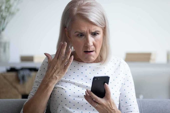 Older woman looking shocked at a smartphone