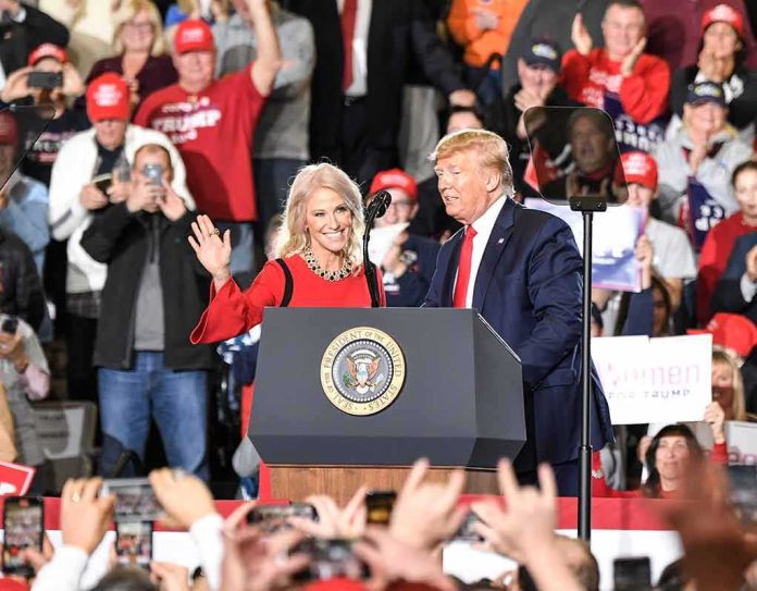 Donald Trump and Russ Huesman on stage at a rally podium