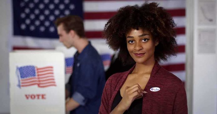 Voter showing an I Voted sticker at a polling place
