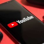 smartphone displaying YouTube logo on red background