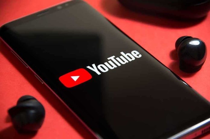 smartphone displaying YouTube logo on red background