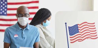 Incumbent Machine Steamrolls New Blood Voters wearing masks at a polling station