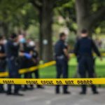 LAPD Confrontation: Pruning Blade, Then Gunfire crime scene tape with police officers in a park