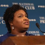 Woman speaking at a podium with microphone
