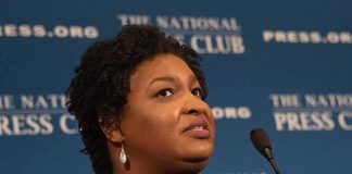 Woman speaking at a podium with microphone