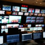 Newsroom Scandal: Harassment, Retaliation Alleged control room with multiple screens and monitors