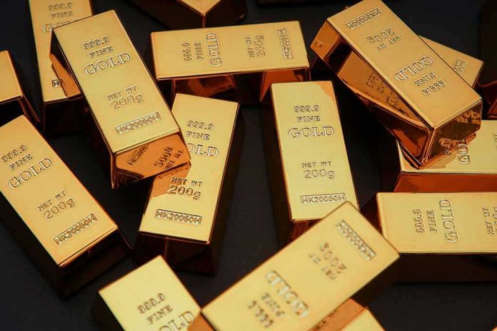 Gold bars stacked and scattered on a dark surface