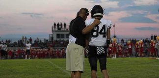 NFL Star Faces Questions After Viral Clips football coach with arm around player number 84 on sideline