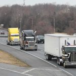 Freedom Haulers Ignites DC Turf War Convoy of semi trucks driving on a multi-lane highway