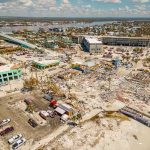 Aerial view of coastal town with widespread storm damage
