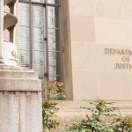 Supremacy Clause Bomb Lands On Campuses Department of Justice building facade with stone sign and window