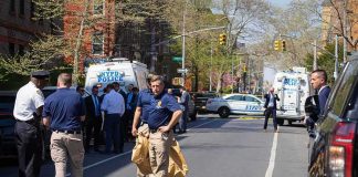 Daylight Gunfire Near Queens Park Police officers and investigators at a blocked city street scene