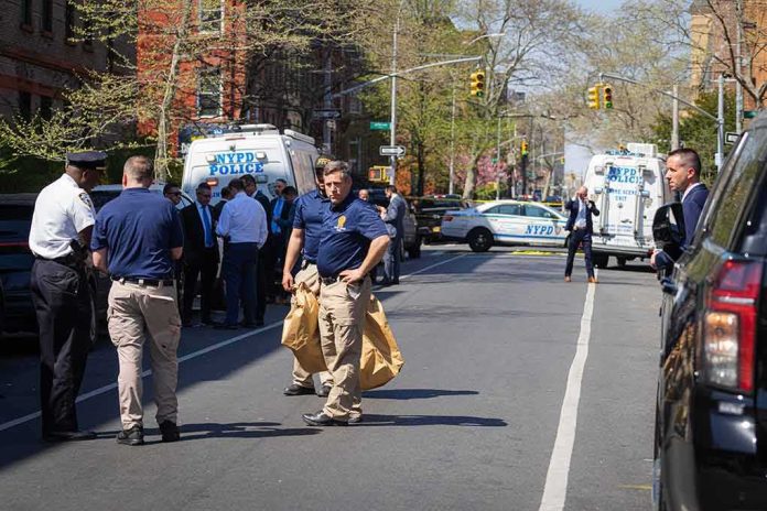 shutterstock_2289044007 Police officers and investigators at a blocked city street scene