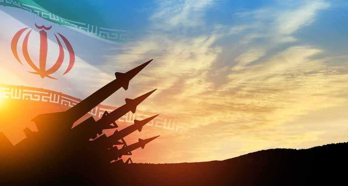 missile silhouettes under Iran flag at sunset