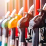 Close-up of fuel pump nozzles at a gas station