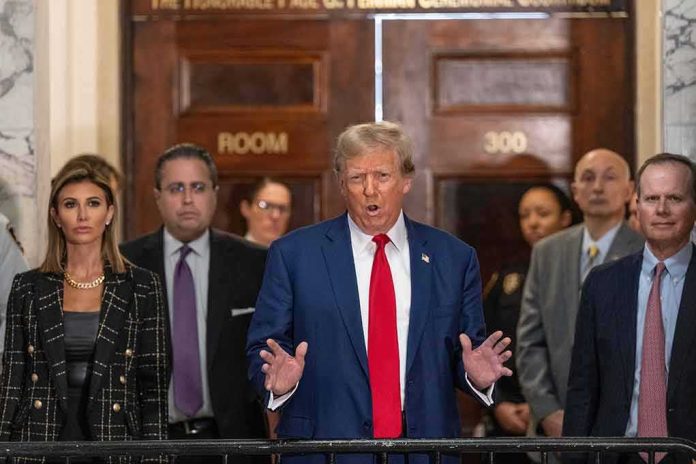 shutterstock_2411512537 Donald Trump speaks at a courthouse hallway podium with officials standing behind him