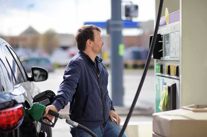 Man refueling a car at a gas station pump