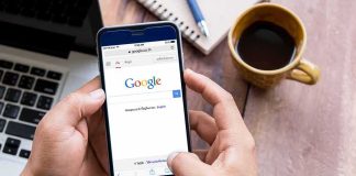 Hands using smartphone with search engine on screen